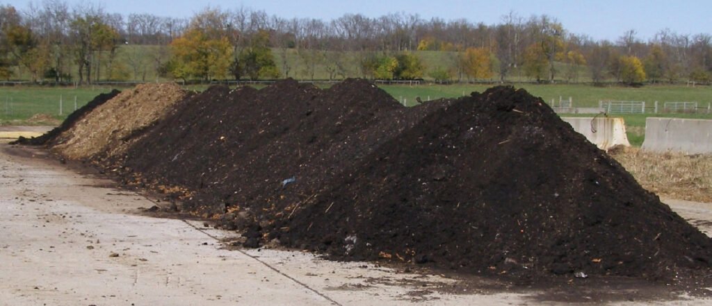 Compacted clay composting pad